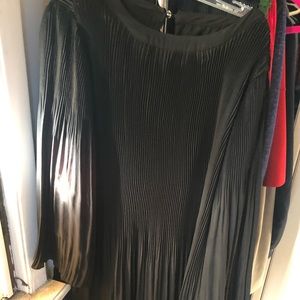 Hardly worn black dress with fluted sleeves .